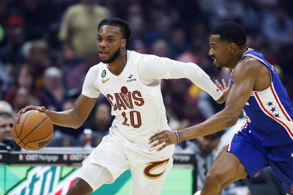 Cleveland Cavaliers guard Darius Garland (10) drives against Philadelphia 76ers guard De'Anthony Melton during the first half of a preseason NBA basketball game, Monday, Oct. 10, 2022, in Cleveland. (AP Photo/Ron Schwane)