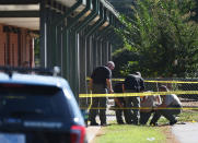 <p>Members of law enforcement investigate an area at Townville Elementary School on Wednesday, Sept. 28, 2016, in Townville, S.C. A teenager opened fire at the South Carolina elementary school Wednesday, wounding two students and a teacher before the suspect was taken into custody, authorities said. (AP Photo/Rainier Ehrhardt) </p>