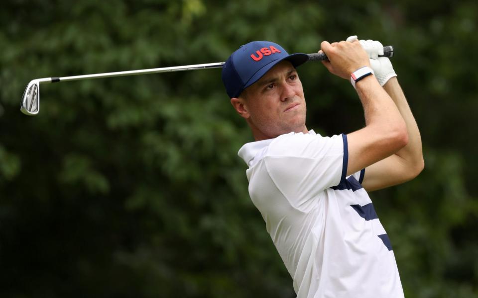  Justin Thomas of Team United States plays his shot from the fourth tee during the first round - Getty Images