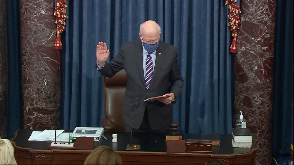 In this image from video, Sen. Patrick Leahy, D-Vt., the president pro tempore of the Senate, who will preside over the impeachment trial of former President Donald Trump, swears in members of the Senate for the impeachment trial against former President Donald Trump in the Senate at the U.S. Capitol in Washington, Tuesday, Jan. 26, 2021. (Senate Television via AP)