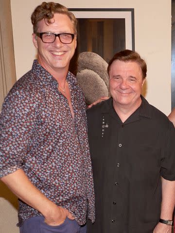 <p>James Bayrami /PMC/Getty</p> Devlin Elliott and Nathan Lane in 2022