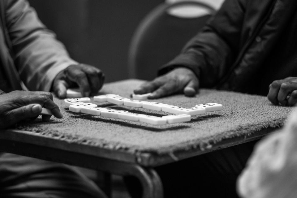 The dominoes bounce into the air as a player slaps the table in victory (Jim Grover)