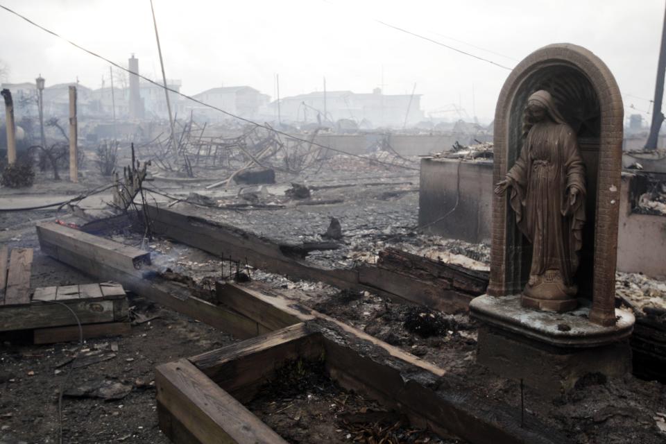 Damage caused by a fire at Breezy Point is shown Tuesday, Oct. 30, 2012, in New York. A fire department spokesman says more than 190 firefighters are at the blaze in the Breezy Point section. Fire officials say the blaze was reported around 11 p.m. Monday in an area flooded by the superstorm that began sweeping through earlier. (AP Photo/Frank Franklin II)