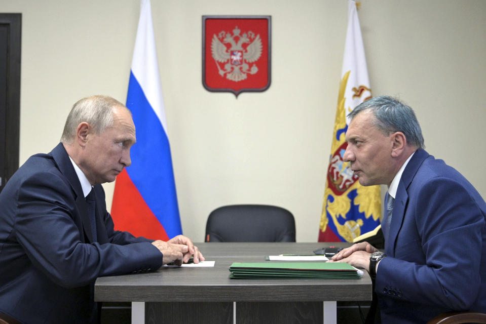 FILE - Russian President Vladimir Putin, left, listens to deputy Prime Minister Yuri Borisov during their meeting after visiting the Zaliv shipyard in Kerch, Crimea, on July 20, 2020. Russian President Vladimir Putin on Friday replaced Russian Roscosmos head Dmitry Rogozin with Yuri Borisov, a deputy prime minister who was in charge of weapons industries. (Alexei Druzhinin, Sputnik, Kremlin Pool Photo via AP, File)