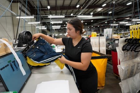 Allissa Barragan folds and boxes up clothes at subscription rental company Le Tote's warehouse in Stockton