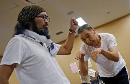 Masayoshi Koiso (R), a 69-year-old homeless man, and Tokuchika Nishi, a 38-year-old homeless man, who are members of Newcomer "H" Sokerissa! - a group of current and former homeless dancers, take part in a practice session in Tokyo, Japan, August 8, 2017. REUTERS/Toru Hanai