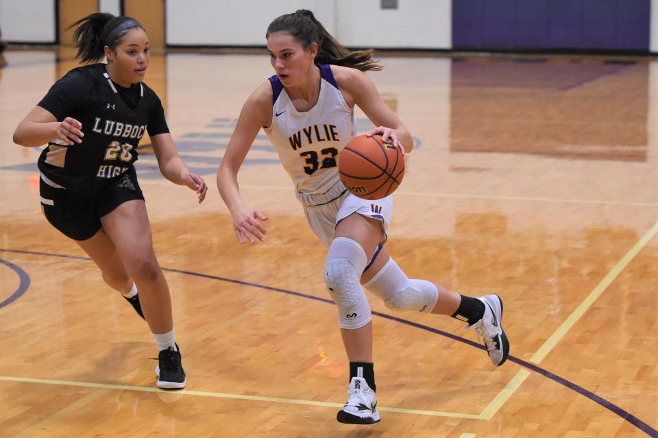 Wylie's Kenyah Maroney (32) drives to the basket during Tuesday's game against Lubbock High. Maroney helped get the offense started and played lock-down defense in the 50-38 win.