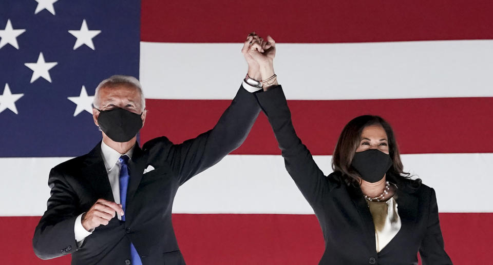 Former Vice President Joe Biden, Democratic presidential nominee, left, and Senator Kamala Harris, Democratic vice presidential nominee, wear protective masks while holding hands outside the Chase Center during the Democratic National Convention in Wilmington, Delaware, U.S., on Thursday, Aug. 20, 2020. Biden accepted the Democratic nomination to challenge President Donald Trump, urging Americans in a prime-time address to vote for new national leadership that will overcome deep U.S. political divisions. Photographer: Stefani Reynolds/Bloomberg via Getty Images