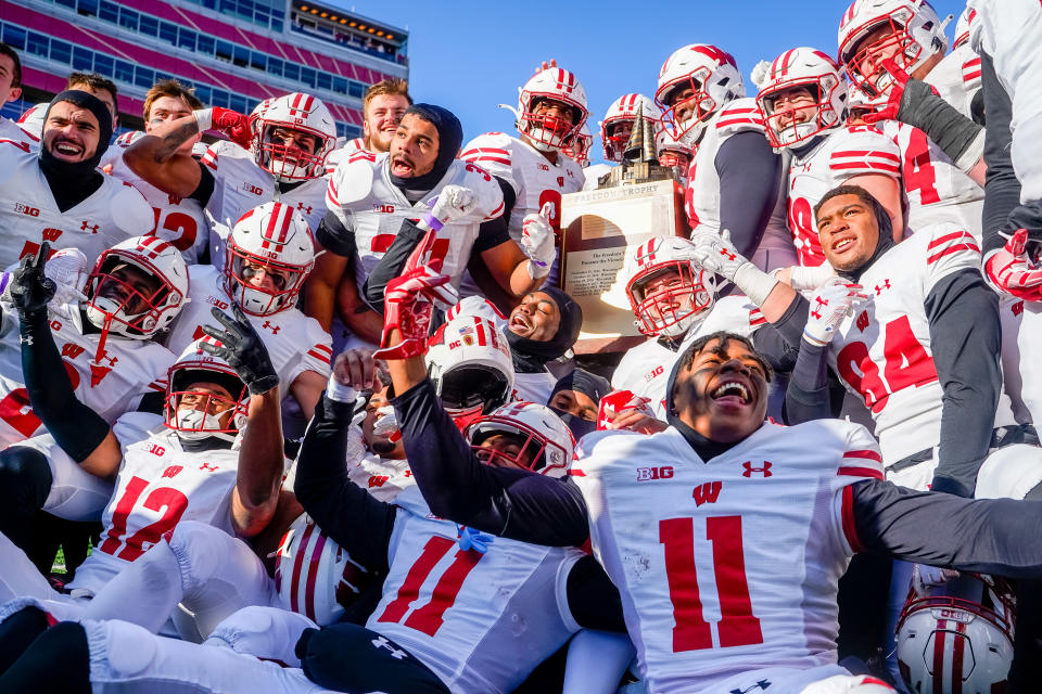 Nov 19, 2022; Lincoln, Nebraska, USA; The Wisconsin Badgers hoist the Freedom Trophy after defeating the <a class="link " href="https://sports.yahoo.com/ncaaf/teams/nebraska/" data-i13n="sec:content-canvas;subsec:anchor_text;elm:context_link" data-ylk="slk:Nebraska Cornhuskers;sec:content-canvas;subsec:anchor_text;elm:context_link;itc:0">Nebraska Cornhuskers</a> 15-14 at Memorial Stadium. <em>Dylan Widger-USA TODAY Sports</em>