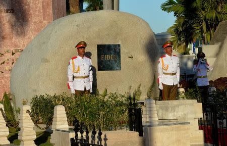 Soldiers stand guard next to a boulder where the ashes of Cuba's former President Fidel Castro were placed by his brother President Raul Castro (not pictured) at the Santa Ifigenia Cemetery, in Santiago de Cuba, December 4, 2016. REUTERS/ACN/Marcelino Vazquez/via REUTERS