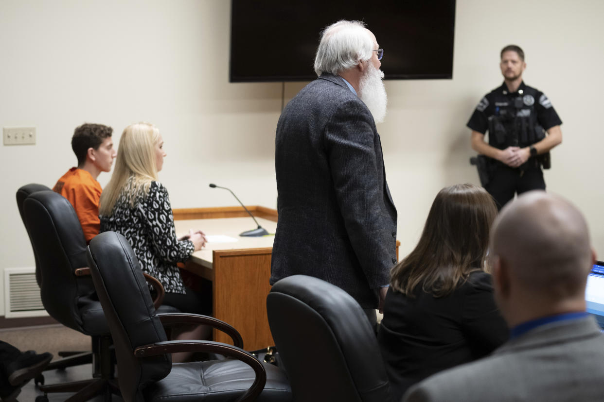 Latah County Prosecutor Bill Thompson, standing, addresses the court during a hearing for Bryan Kohberger, left, who is accused of killing four University of Idaho students in November 2022, Thursday, Jan. 5, 2023, in Latah County District Court, in Moscow, Idaho. (AP Photo/Ted S. Warren, Pool)