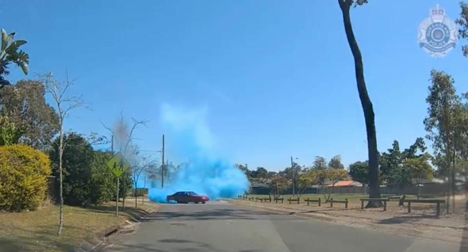 Queensland Police have released dash-camera footage of a red Holden Commodore VP conducting a gender reveal as part of the investigation into the dangerous operation of a vehicle at Logan on Saturday. Source: Queensland Police 