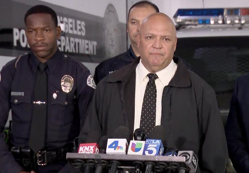 Det. Ryan Moreno of the LAPD South Traffic Division, center, speaks at press conference asking for help to ID victim