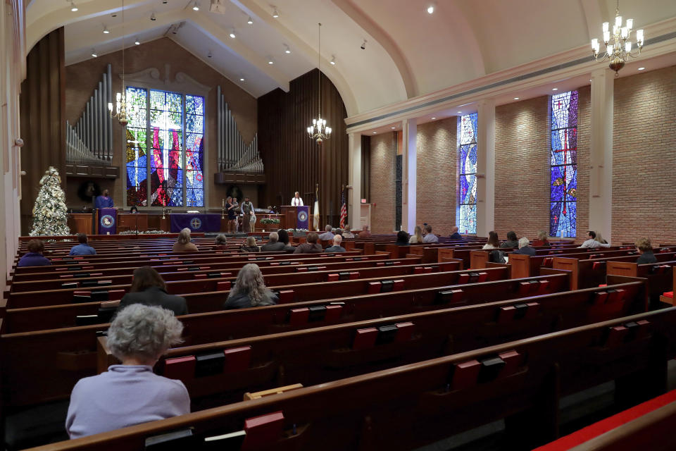 Rev. Meredith Mills delivers a sermon from the pulpit for some 30 attendants during the second service of the day in the sanctuary at Westminster United Methodist Church Sunday, Dec. 12, 2021, in Houston. The church holds two Sunday services. The first is a looser, more contemporary service with an electric band that is better attended by families with children held in the Fellowship Hall. The second is the traditional service held in the sanctuary. (AP Photo/Michael Wyke)