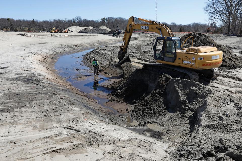 Excavators dig the trenches for a new brook during Phase 1 of the two phase project by Buzzards Bay Coalition re-introducing marshes onto Marsh Island on the Fairhaven side of New Bedford's north harbor.