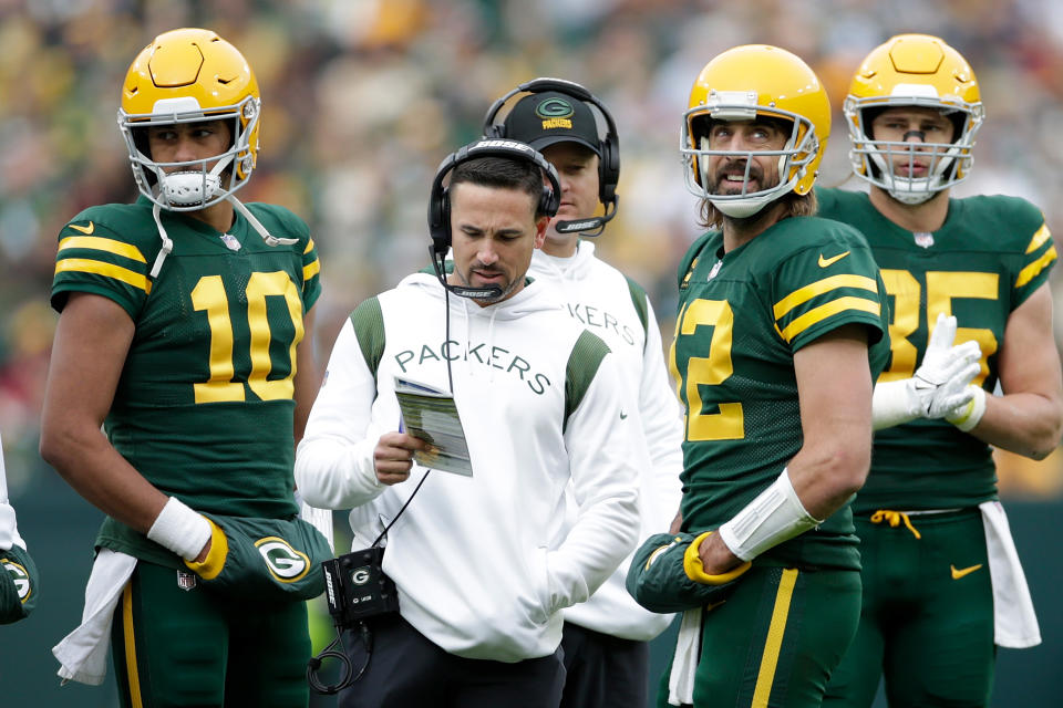 GREEN BAY, WISCONSIN - OCTOBER 24: Aaron Rodgers #12 talks with Green Bay Packers head coach Matt LaFleur as Jordan Love #10 listens during the game against the Washington Football Team  at Lambeau Field on October 24, 2021 in Green Bay, Wisconsin. Green Bay defeated Washington 24-10. (Photo by John Fisher/Getty Images)