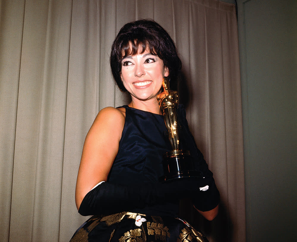 Moreno in 1962 with her Oscar for best supporting actress. - Credit: Bettmann Archive/Getty Images