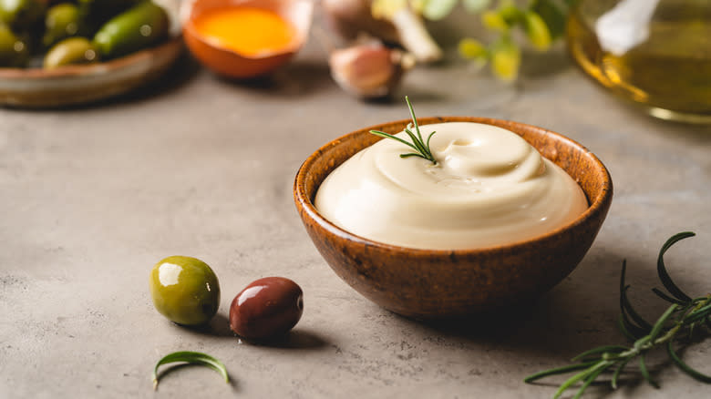 mayonnaise with garnish beside olives