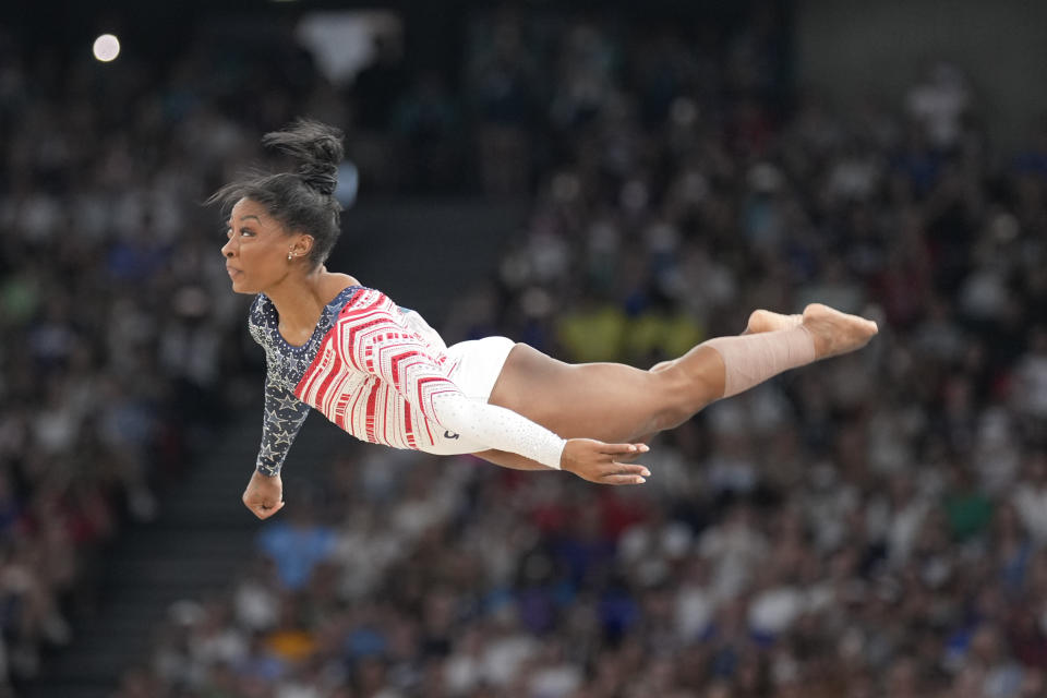 Biles appears to be flying as she performs her floor exercise during the women's artistic gymnastics team finals.