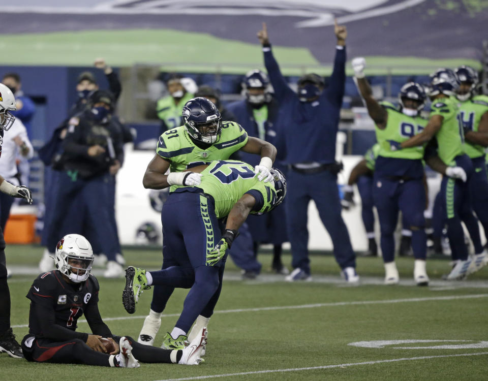 Seattle Seahawks defensive end Carlos Dunlap (43) celebrates with defensive end L.J. Collier (91) after Dunlap sacked Arizona Cardinals quarterback Kyler Murray, left, late in the second half of an NFL football game, Thursday, Nov. 19, 2020, in Seattle. The Seahawks won 28-21. (AP Photo/Lindsey Wasson)