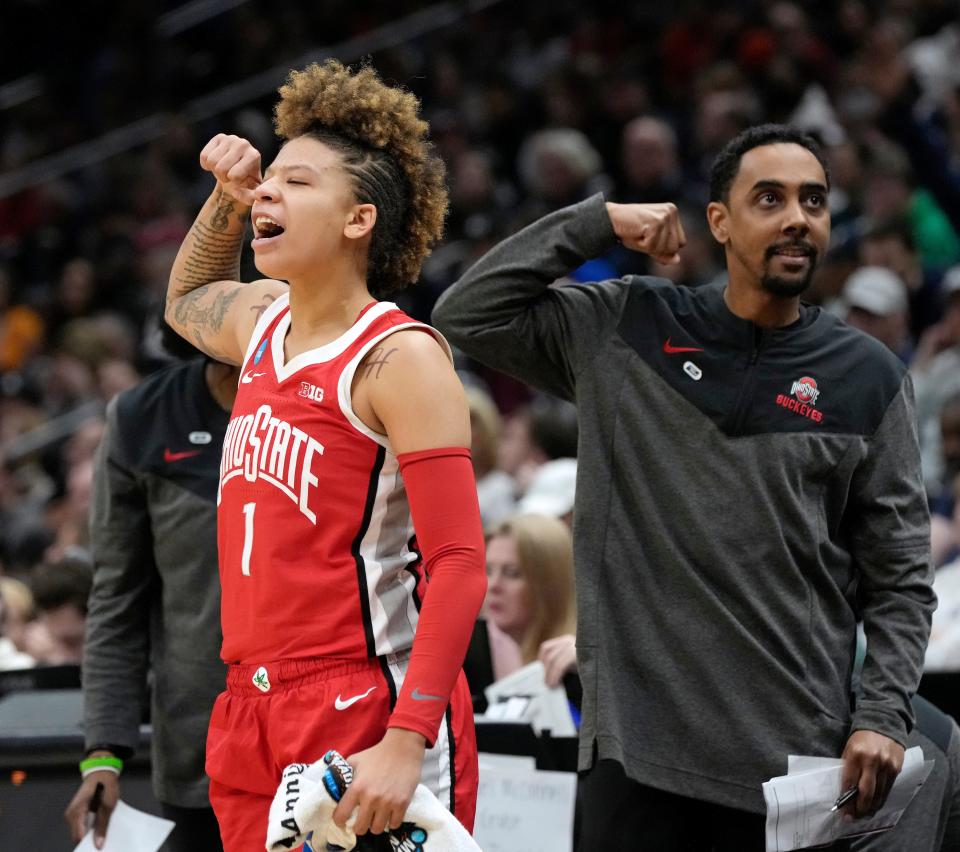 March 25, 2023; Seattle, WA, USA; Ohio State Buckeyes guard Rikki Harris (1) and assistant coach Wesley Brooks flex from the bench during the second half of an NCAA Tournament Sweet Sixteen game against the UConn Huskies at Climate Pledge Arena in Seattle on Saturday. Ohio State won the game 73-61.Mandatory Credit: Barbara J. Perenic/Columbus Dispatch