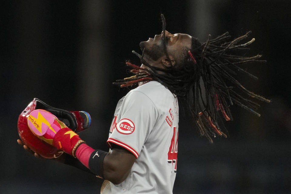 Cincinnati Reds' Elly De La Cruz adjusts his helmet after stealing second base during the fifth inning of a baseball game against the Los Angeles Dodgers in Los Angeles, Thursday, May 16, 2024. (AP Photo/Ashley Landis)