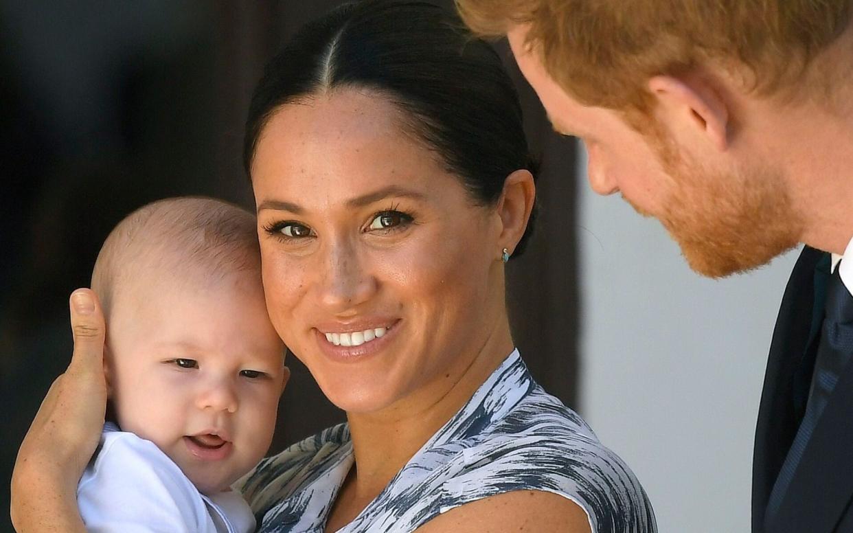 The Duchess of Sussex, pictured with son Archie and the Duke, argued parents should not be forced to ‘choose between earning a living and having the freedom to take care of their child’ - Shutterstock