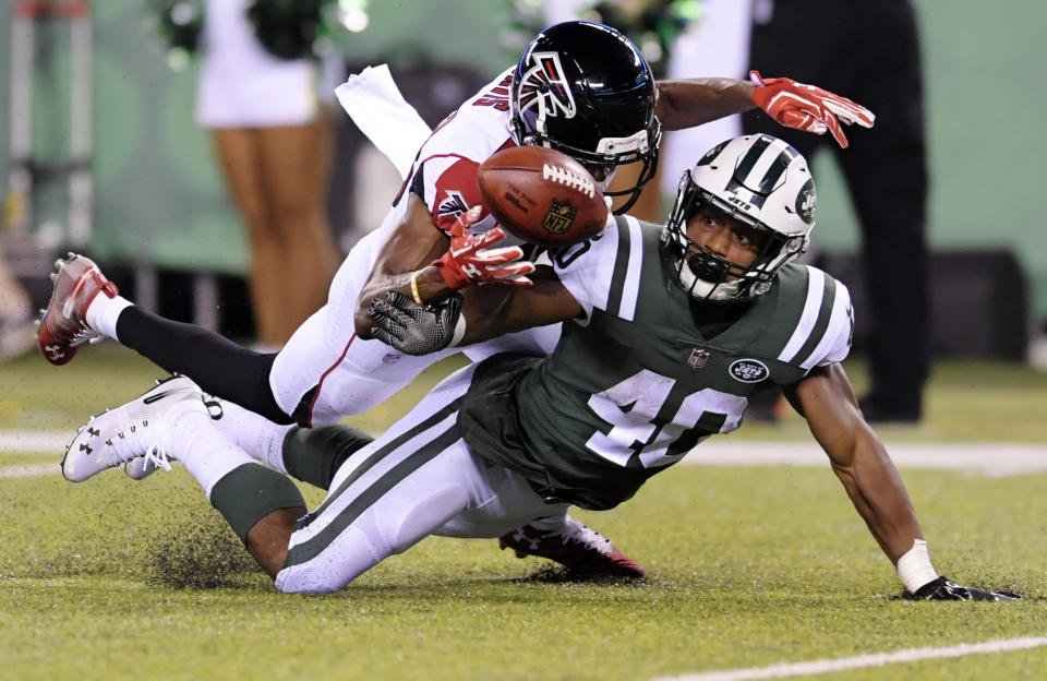 Atlanta Falcons wide receiver Reggie Davis defends against New York Jets' Trenton Cannon (40) during the second half of a preseason NFL football game Friday, Aug. 10, 2018, in East Rutherford, N.J. (AP Photo/Bill Kostroun)