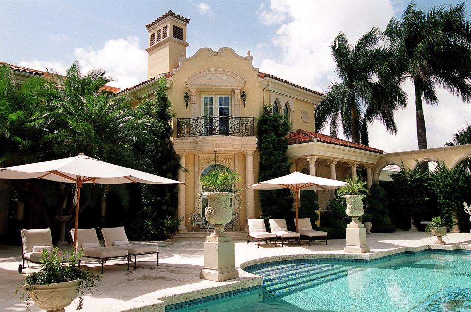 In this September 2002 photo, former residence of Celine Dion and her late husband, Rene Angelil, in Admirals Cove in Jupiter was on the market for $20 million. This was the scene from the backyard pool and patio area, looking toward the rear of the house, the west tower and balcony.