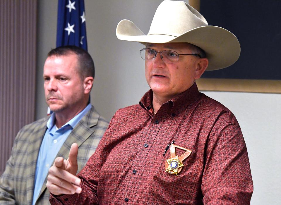 Taylor County Sheriff Ricky Bishop stands beside Abilene Police Department Chief Ron Seratte during Thursday’s announcement of a major drug bust for Abilene and the surrounding counties Feb. 22, 2024. Bishop said 17 people were arrested in raids on Wednesday carried out by local, state and federal agents.