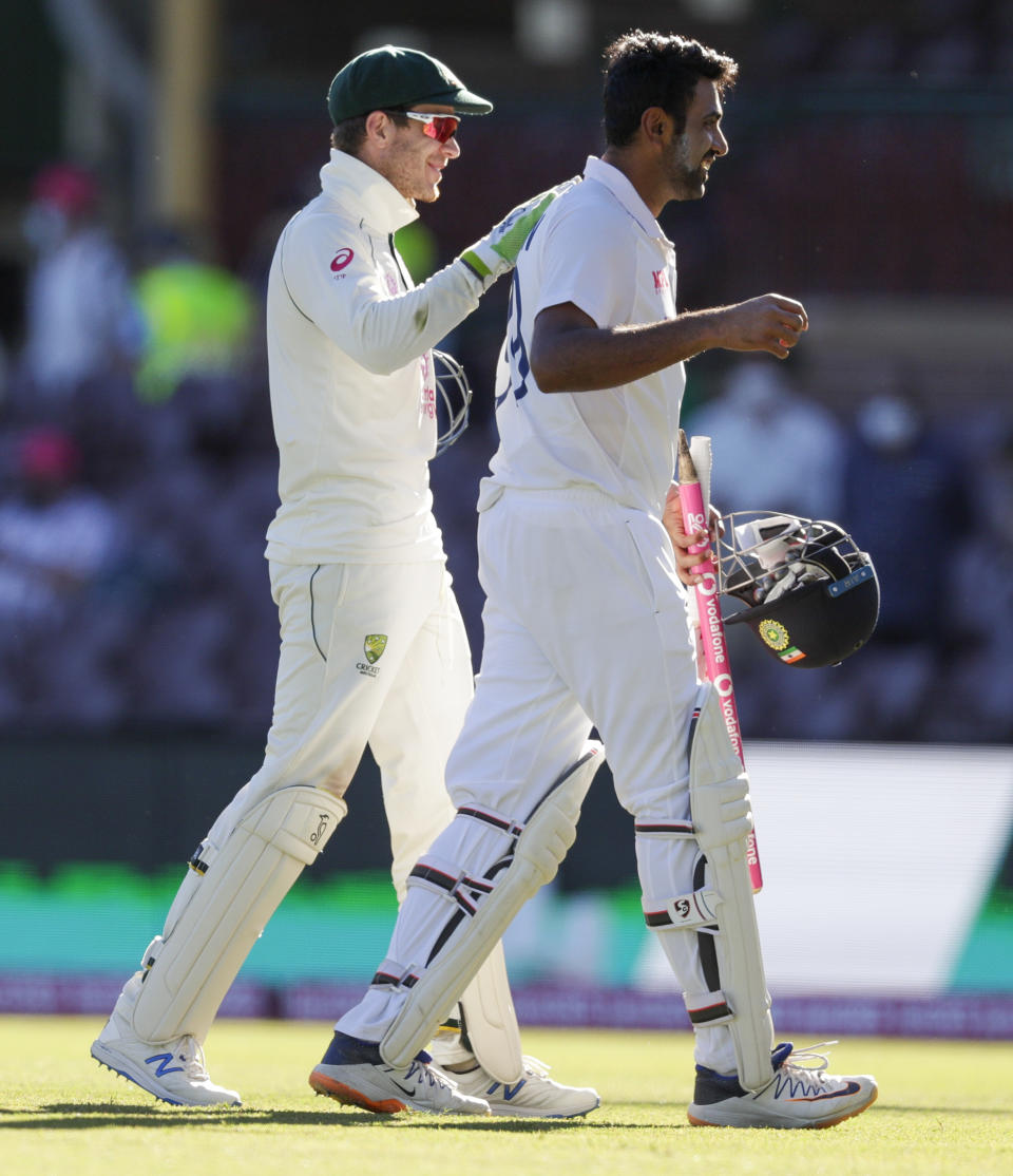 Australian captain Tim Paine, left, congratulates not out batsman India's Ravichandran Ashwin following play on the final day of the third cricket test between India and Australia at the Sydney Cricket Ground, Sydney, Australia, Monday, Jan. 11, 2021. The test ended in a draw and the series is at 1-1 all with one test to play. (AP Photo/Rick Rycroft)