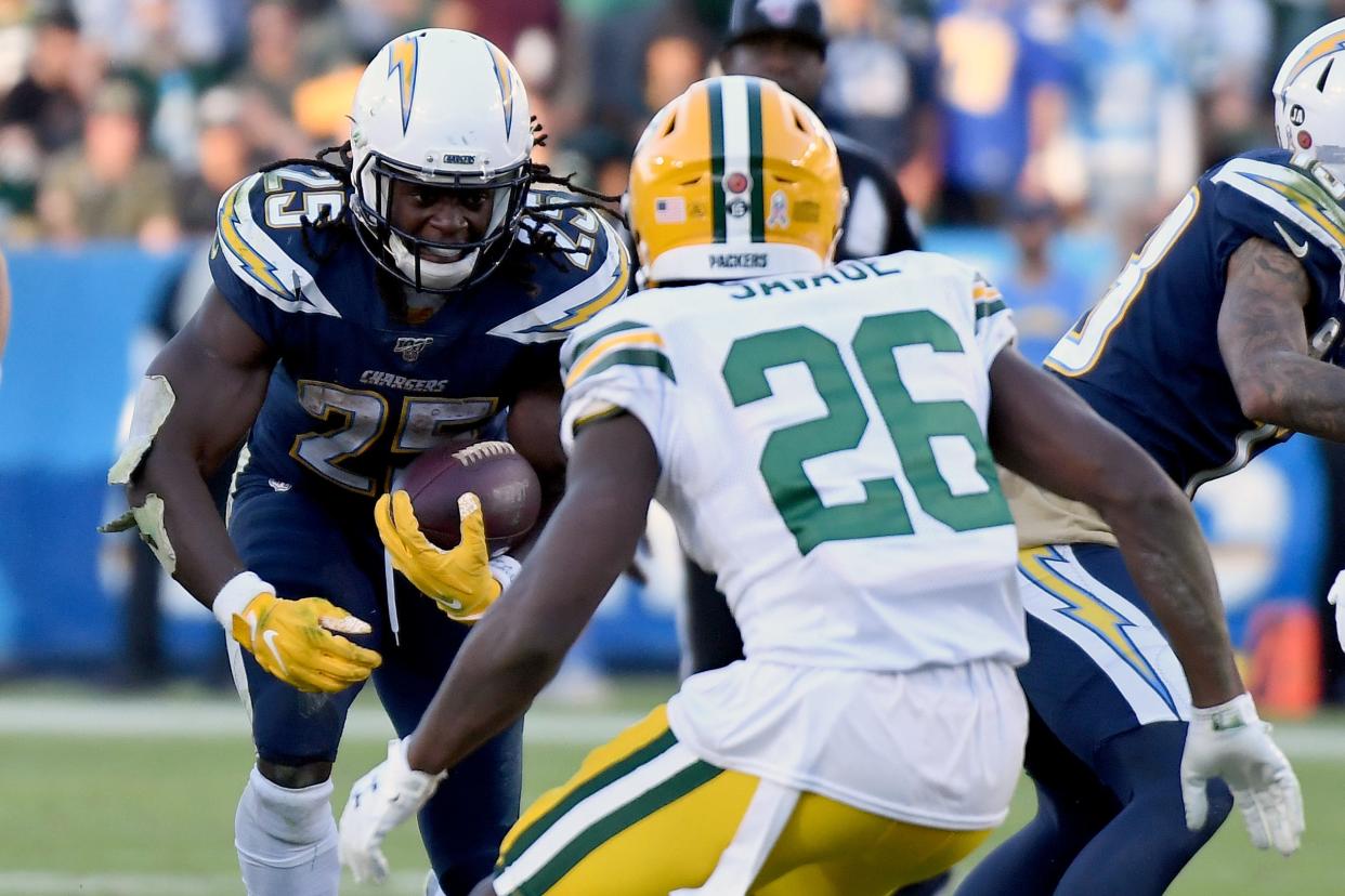 Chargers running back Melvin Gordon carries the ball against Green Bay Packers defensive back Darnell Savage during the fourth quarter at Dignity Health Sports Park in Los Angeles on Nov. 3, 2019, the last time the teams played. Gordon is now with the Baltimore Ravens. Savage remains with the Packers. The Chargers won the game 26-11.