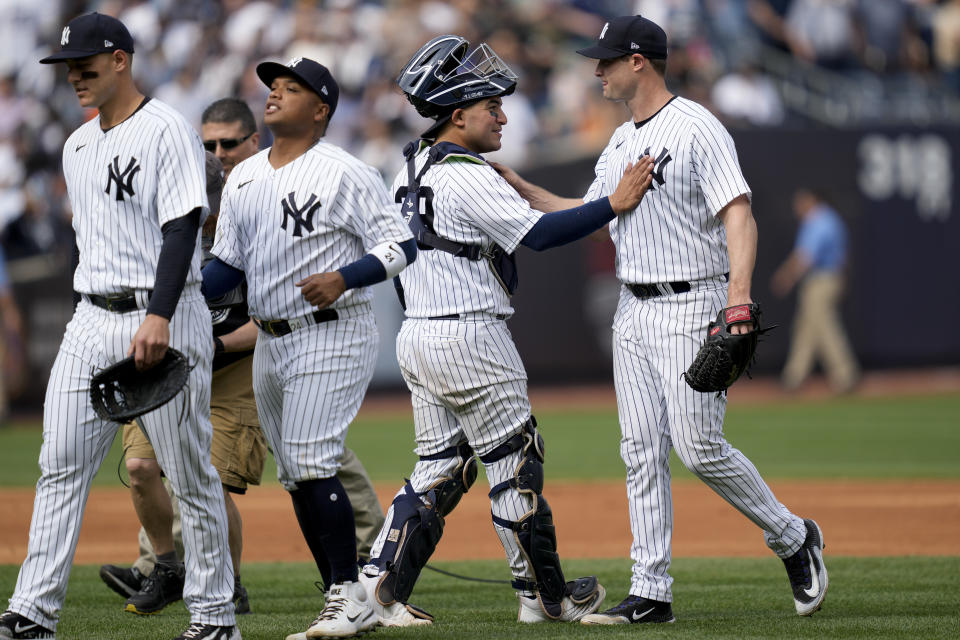 New York Yankees starting pitcher Gerrit Cole, right, celebrates with his teammates after closing the ninth inning of a baseball game against the Minnesota Twins to record a complete game shutout, Sunday, April 16, 2023, in New York. (AP Photo/John Minchillo)