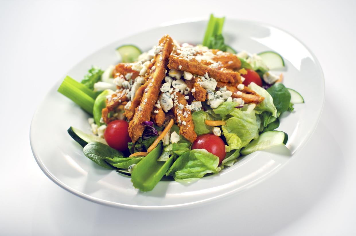 Boneless chicken wings tossed in Buffalo sauce with salad and blue cheese crumbles.