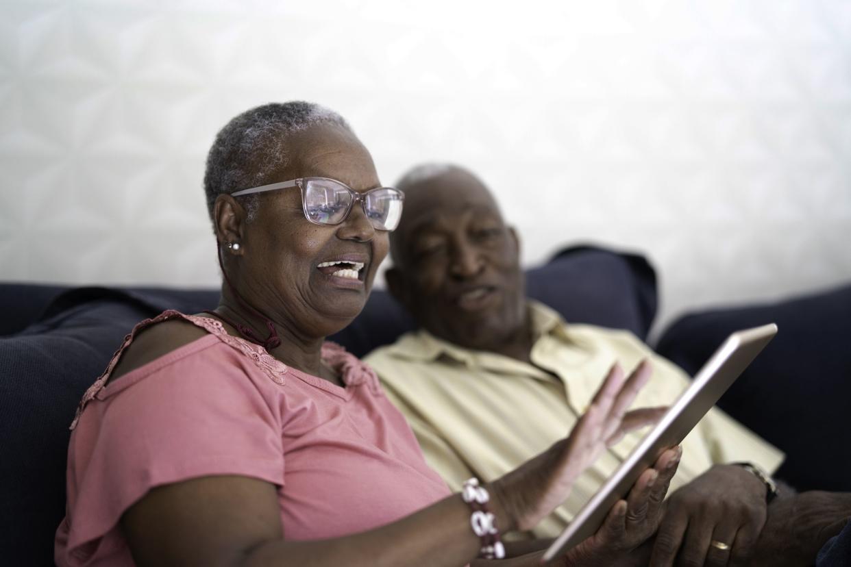 senior couple using digital tablet