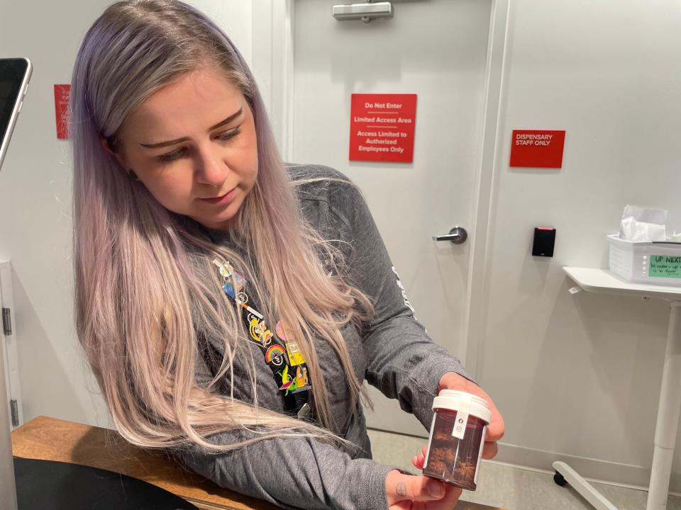 Willimantic Fine Fettle Front Desk Lead Yohannah Roda-McNaboe shows a medical cannabis product.