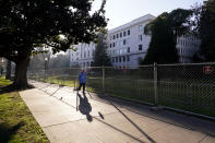 A temporary six-foot high chain link fence surrounds the state Capitol because of concerns over the potential for civil unrest, in Sacramento, Calif., Thursday, Jan. 14, 2021. With the FBI warning of potential violence at all state capitols Sunday, Jan. 17, the ornate halls of government and symbols of democracy looked more like heavily guarded U.S. embassies in war-torn countries. (AP Photo/Rich Pedroncelli)