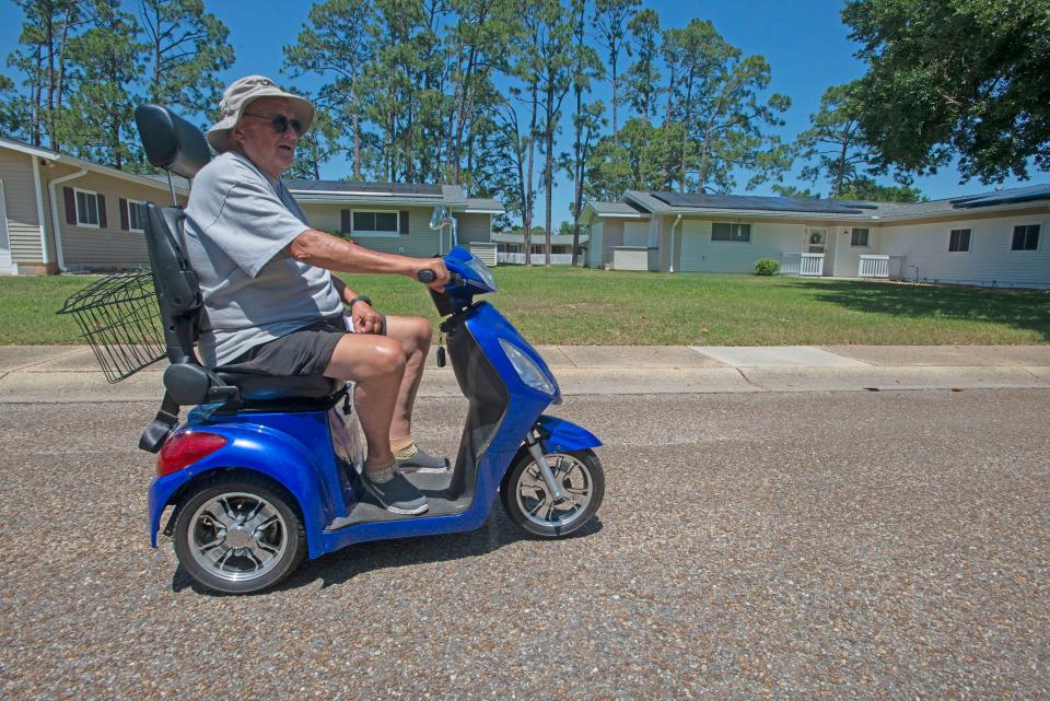 Navy veteran Frank Gregory cruises the streets of Corry Village on Wednesday. Gregory is one of several retired military veterans asked to vacate the military housing complex to accommodate active-duty service members.