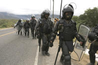 Guatemalan soldiers make a shift change at a police checkpoint on the Motagua River to stop the advance of Honduran migrants in Zacapa, Guatemala, Tuesday, Jan. 19, 2021. A once large caravan of Honduran migrants that pushed its way into Guatemala last week had dissipated by Tuesday in the face of Guatemalan security forces. (AP Photo/Oliver de Ros)