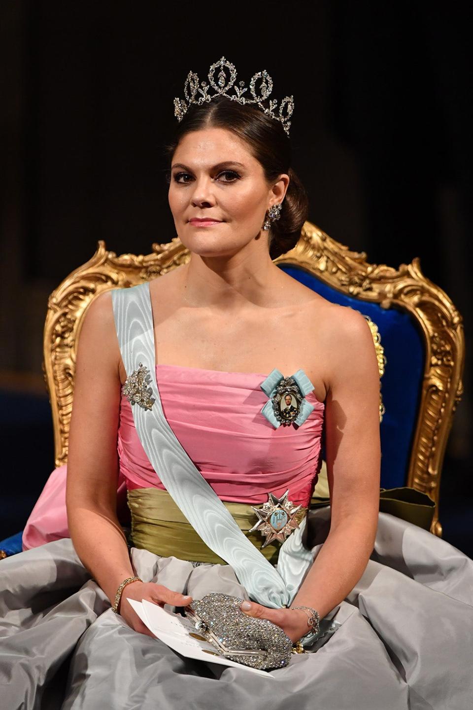 Crown Princess Victoria wearing a pink strapless gown with a white sash and a tiara