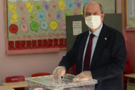 Ersin Tatar, candidate and prime minister of a self-declared Turkish Cypriot state recognized only by Turkey, casts his ballot at a polling station in the Turkish occupied area in the north part of the divided capital Nicosia, Cyprus, Sunday, Oct. 18, 2020. Turkish Cypriots are voting in a leadership runoff to chose between an incumbent who pledges a course less bound by Turkey’s dictates and a challenger who favors even closer ties to Ankara. (AP Photo/Nedim Enginsoy)