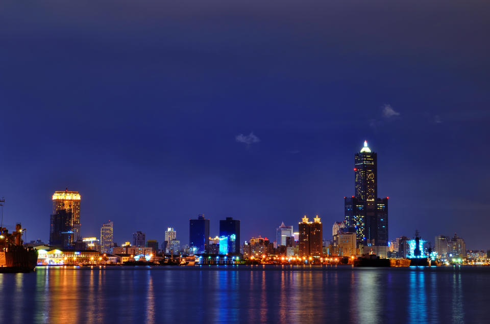 Night view of Kaohsiung City with reflection of skyline in water.