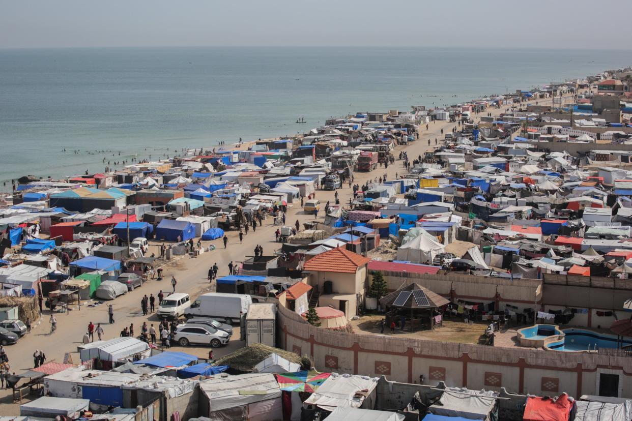 Tents housing internally displaced Palestinians crowd the beach and the Mediterranean shoreline in Deir el-Balah in the central Gaza Strip (AFP via Getty Images)