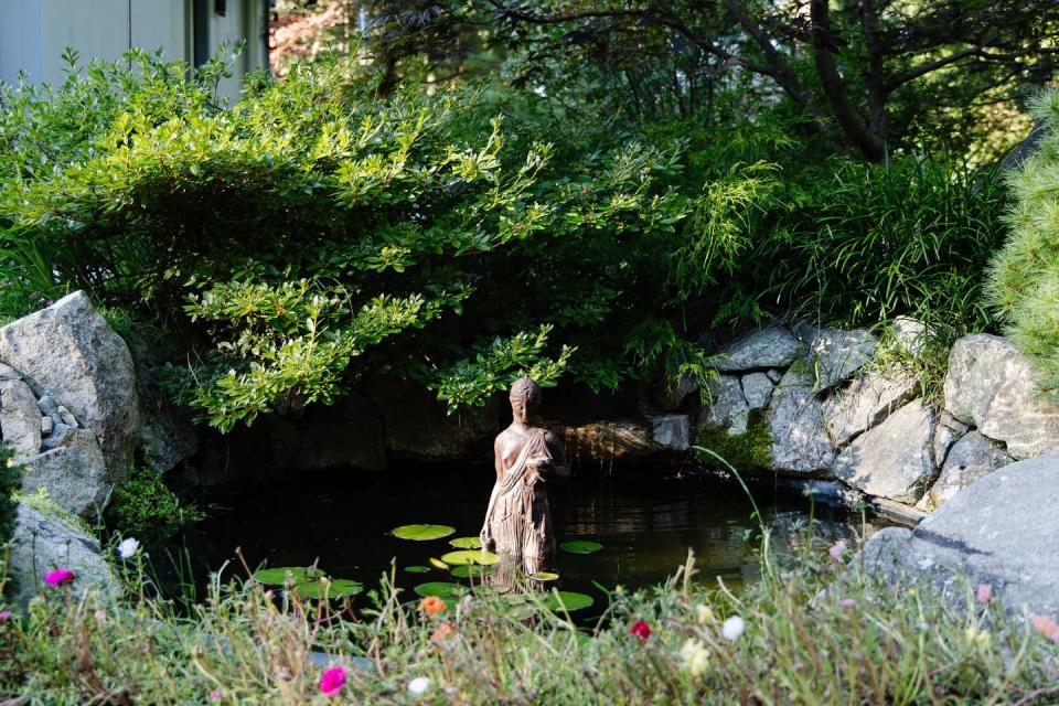 statue in koi pond