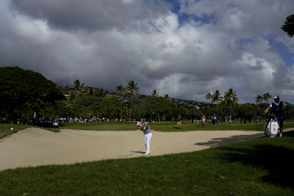 Si Woo Kim hits from the bunker on the 18th fairway during the final round of the Sony Open golf tournament, Sunday, Jan. 15, 2023, at Waialae Country Club in Honolulu. (AP Photo/Matt York)