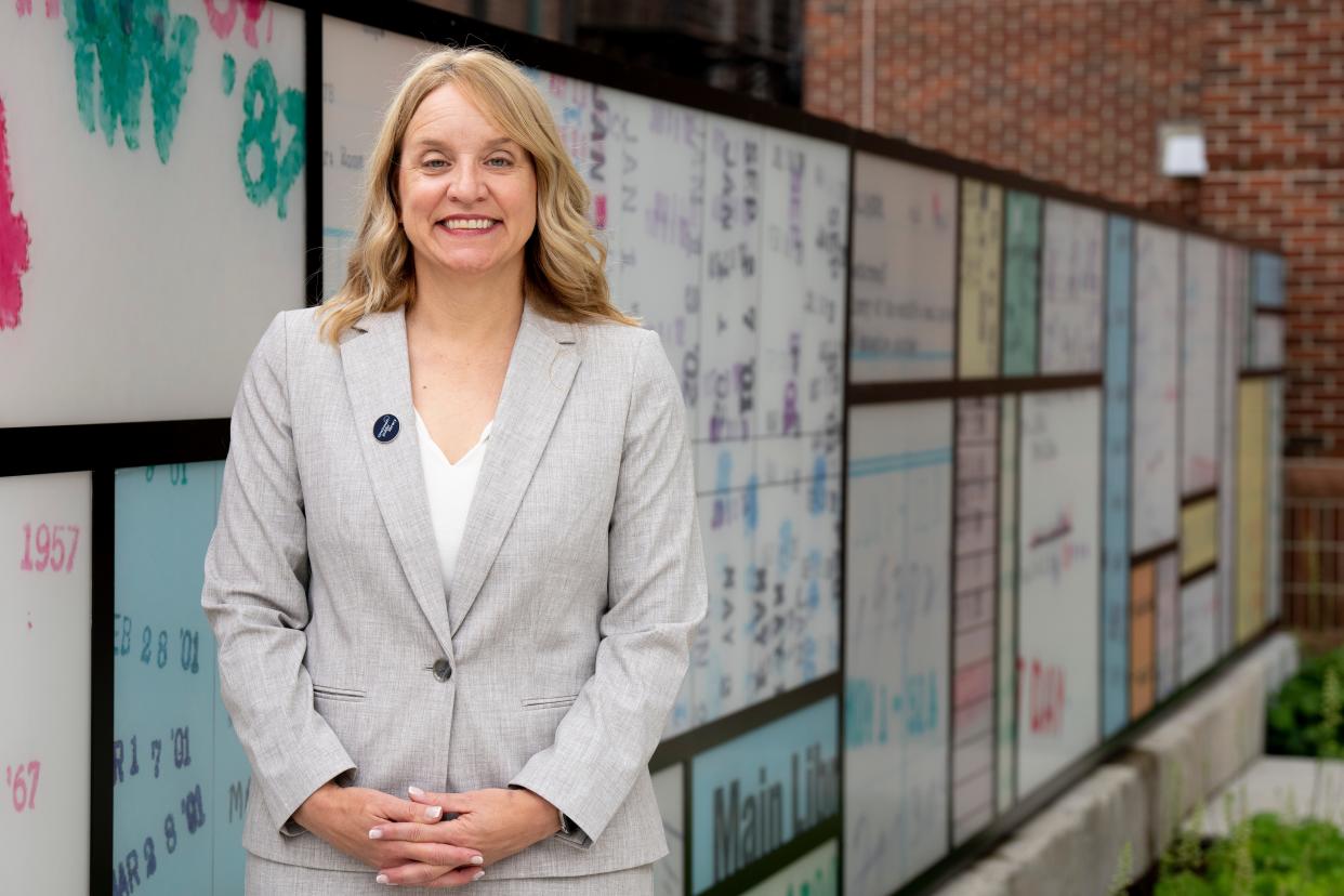Paula Brehm-Heeger, the Eva Jane Romaine Coombe Director of Cincinnati-Hamilton County Public Library, stands outside the library in Cincinnati on Thursday, July 13, 2023. 