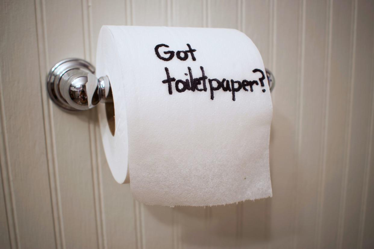 writing on a toilet paper roll hanging in a bathroom reads, Got Toilet Paper?