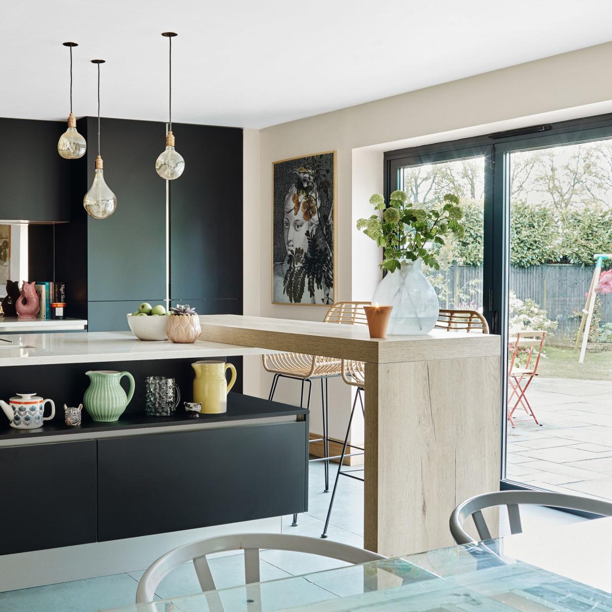  Kitchen diner with breakfast bar, sliding patio doors and pendant lights. 