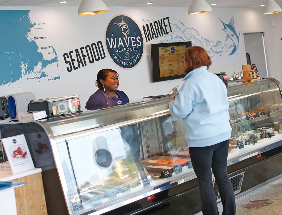 Waves Seafood owner Kara Kelley waits on a customer.