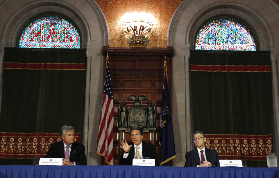 New York Gov. Andrew Cuomo, center, speaks during a news conference in the Red Room at the Capitol as Senate Majority Leader Dean Skelos, R-Rockville Center, left, and Assembly Speaker Sheldon Silver, D-Manhattan, listen in Albany, N.Y., on Tuesday, May 22, 2012. Cuomo says a new, temporary board set to run the New York Racing Association will enhance racing while working on the state's expansion of gambling. (AP Photo/Mike Groll)